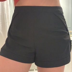 Adorable high waisted black shorts with leg slit.